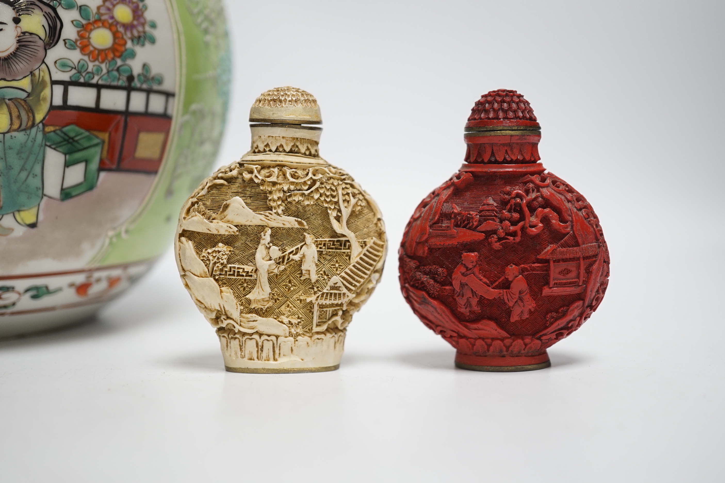 An early 20th century Japanese famille rose snuff bottle together with three others and a lidded jar